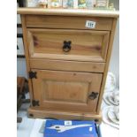A pine bedside cabinet with iron fittings
