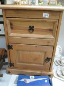 A pine bedside cabinet with iron fittings