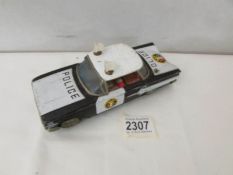 A Japanese tinplate friction police car by Ichiko.