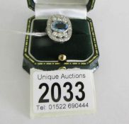A magnificent platinum ring set with a central oval cut aquamarine stone flanked by 6 diamonds and