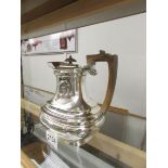 A silver hot water jug, hall marked for Sheffield 1912/13, Maker RXB. Approximately 630 grams.