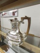 A silver hot water jug, hall marked for Sheffield 1912/13, Maker RXB. Approximately 630 grams.