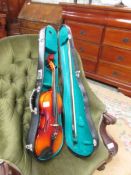 A cased violin with bow.