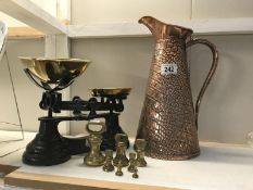 A set of kitchen scales with brass weights and copper jug