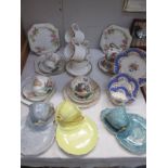 A quantity of porcelain tea cups and saucers and sandwich plate sets