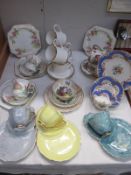 A quantity of porcelain tea cups and saucers and sandwich plate sets