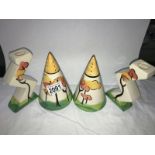 A pair of candlesticks and sugar sifters in the style of Clarice Cliff,