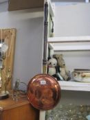 A copper warming pan and a brass dust pan