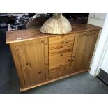 A solid pine 2 door cupboard with drawers