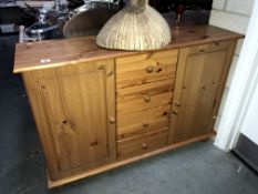 A solid pine 2 door cupboard with drawers