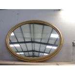 A large oval gilt framed mirror