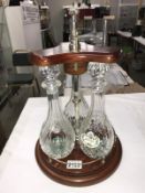 3 decanters on a railed wood stand