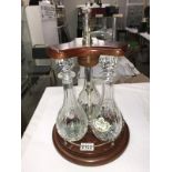 3 decanters on a railed wood stand