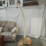 A large imitation elephant tusk standard lamp.