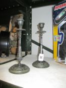 A pair of cast metal candlesticks