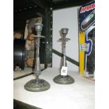 A pair of cast metal candlesticks