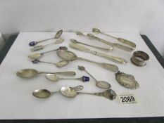 A mixed lot of silver ware including spoons, napkin rings, sugar nips etc., approximately 325 grams.