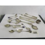 A mixed lot of silver ware including spoons, napkin rings, sugar nips etc., approximately 325 grams.