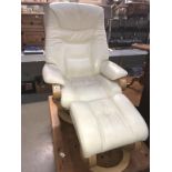 A reclining cream leather armchair with matching footstool