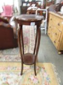 A mahogany plant stand.