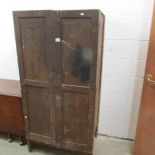 An old industrial wooden cupboard with drawers.