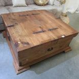 A large rustic style coffee table with storage.