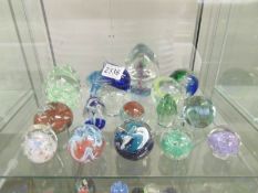17 assorted glass paperweights.