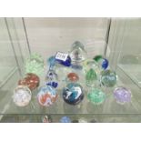 17 assorted glass paperweights.