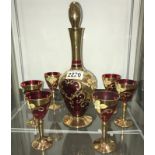 A superb gilt & ruby glass overlaid decanter & 6 glasses