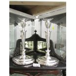 A pair of tall silver candlesticks on oval bases, hall marked for Sheffield 1918/19, Maker H.E Ltd.