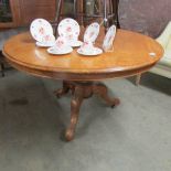 A pale mahogany tripod dining table.