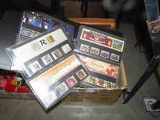 A box of stamp albums, mint sets, presentation packs etc.
