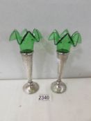 A pair of silver and green glass specimen vases, hall marked Birmingham 1918/19.