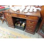 A mahogany kneehole desk.