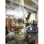 A Victorian oil lamp with original acid etched shade.