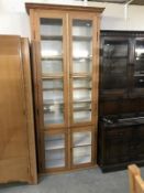 An antique pine kitchen cupboard with glazed doors
