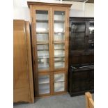 An antique pine kitchen cupboard with glazed doors