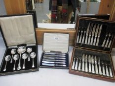A boxed set of 12 knives/forks with mother of pearl handles (1 knife missing) and other boxed