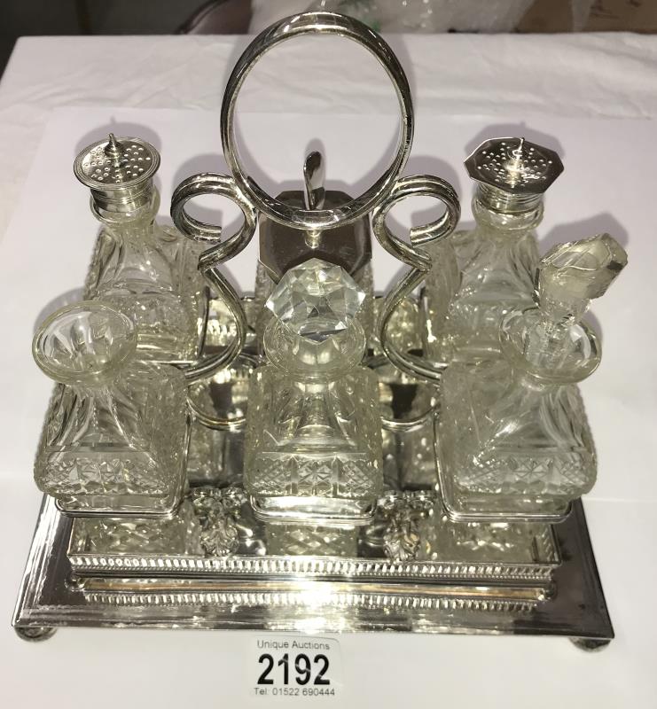 A 6 bottle cruet set on silver plated stand