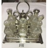 A 6 bottle cruet set on silver plated stand