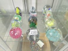 12 assorted glass paperweights.