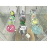 12 assorted glass paperweights.