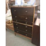 A dark wood stained retro chest of drawers