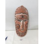 A Papua New Guinea mask: a carved wood tribal mask from Papua New Guinea with inset cowrie shell