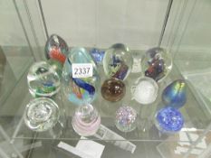 16 assorted glass paperweights.