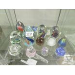 16 assorted glass paperweights.