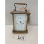 A brass carriage clock complete with key and in working order.