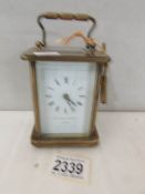 A brass carriage clock complete with key and in working order.