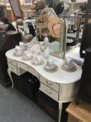 A white kidney shaped bedroom dressing table
