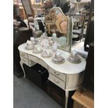A white kidney shaped bedroom dressing table